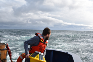 Andrew Reed tossing SOFAR spotter buoy