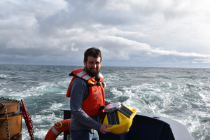 Andrew Reed tossing SOFAR spotter buoy