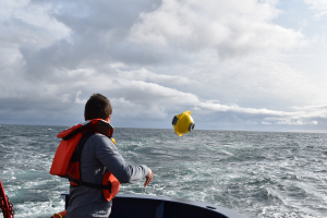 Andrew Reed tossing SOFAR spotter buoy