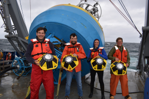 Irminger 8 team holding SOFAR spotter buoys