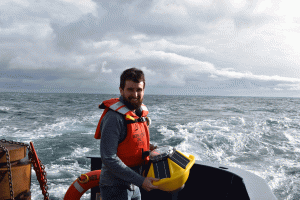 Andrew Reed tossing the SOFAR spotter buoy