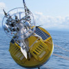 Installation Continues and O&M Begins at the Endurance Array The Oregon shelf surface mooring is lowered to the water using the R/V Oceanus ship's crane. (Photo Credit: OOI Endurance Array Program, OSU)