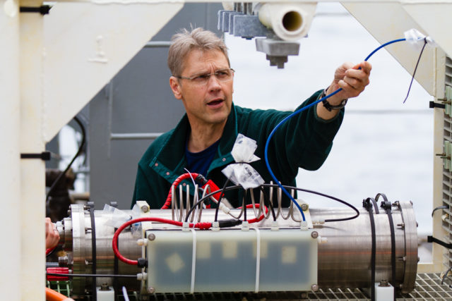 UW Scientist Orest Kawka preparing the mass spectrometer (MASSP) instrument for deployment in 2014. Photo by Ed McNichol.