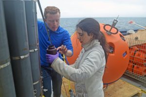 Elizabeth learns how to take water samples from the Niskin bottles for data verification of Cabled Array instruments. Credit University of Washington.