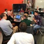 Two groups deep in conversation about their work on data validation and simplified data access. Credit: Rachael Murray, eScience Institute