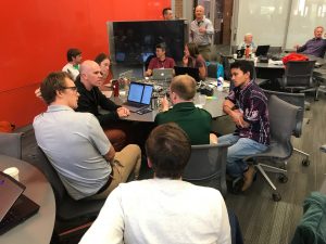 Two groups deep in conversation about their work on data validation and simplified data access. Credit: Rachael Murray, eScience Institute