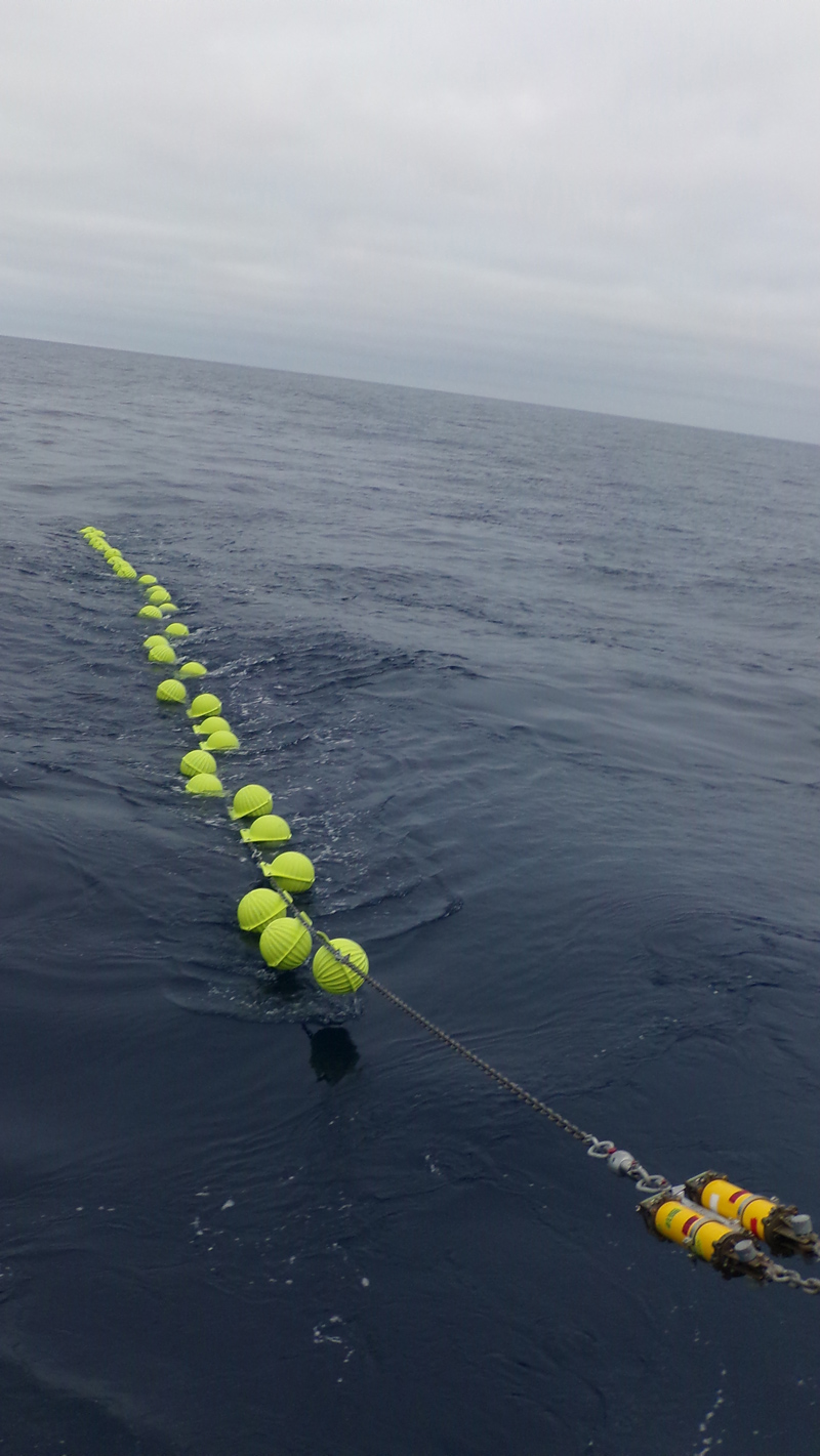 Glass balls and dual acoustic releases are deployed for Mesoscale Flanking Mooring-B (MFM-B) (Photo Credit: Bill Bergen, OOI Program Management Office)