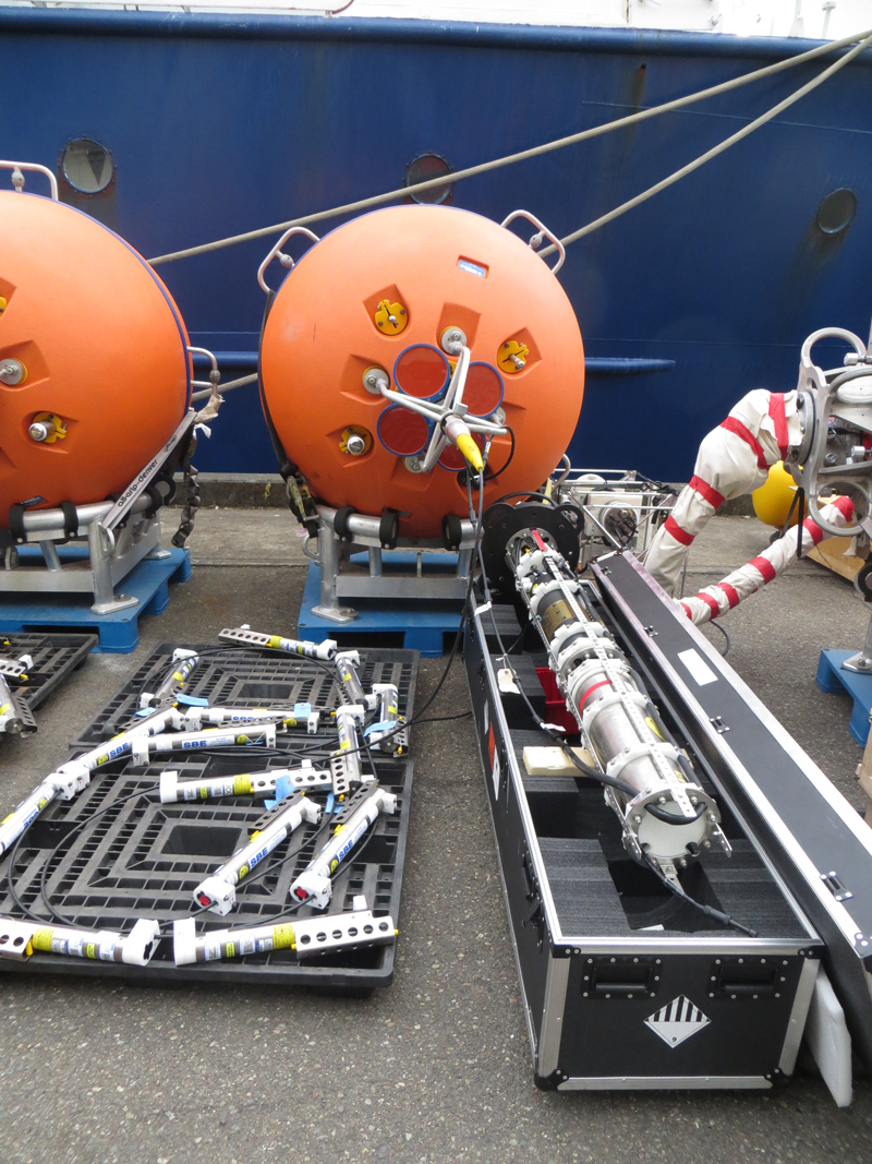 Mooring equipment and sensors are arranged and tested on UW pier in Seattle prior to loading on ship. (Photo Credit: Brian Beanlands, Department of Fisheries and Oceans, Canada)