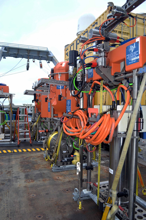 Profiler Science Pods Waiting to be Installed - A line of shallow winched profilers and instrumented platform interface assemblies await installation on 2-legged Shallow Profiler Moorings that provide real-time data on chemical, biological, and physical properties of ocean waters off the coast of Oregon. Photo Credit. Deb Kelley, University of Washington, V15.