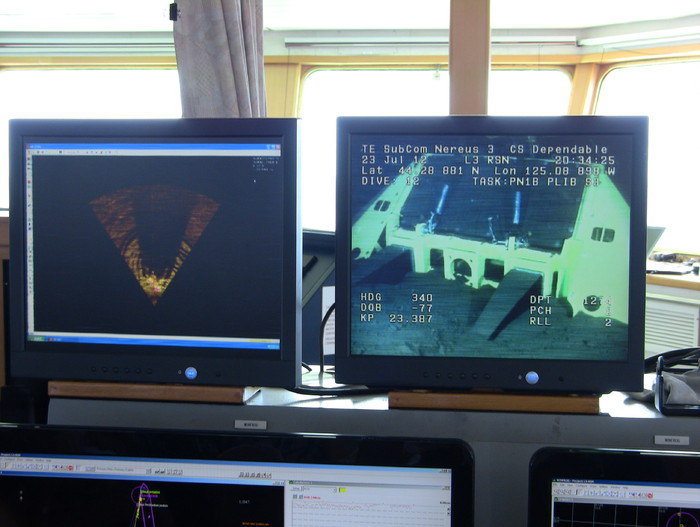 Screen monitors on the bridge of the TE SubCom CS Dependable show sonar and video displays from the ROV Nereus 3 during final inspection of node PN1B. Note the node sitting nice and flat on the seabed in video display. Photo by Cecile Durand 