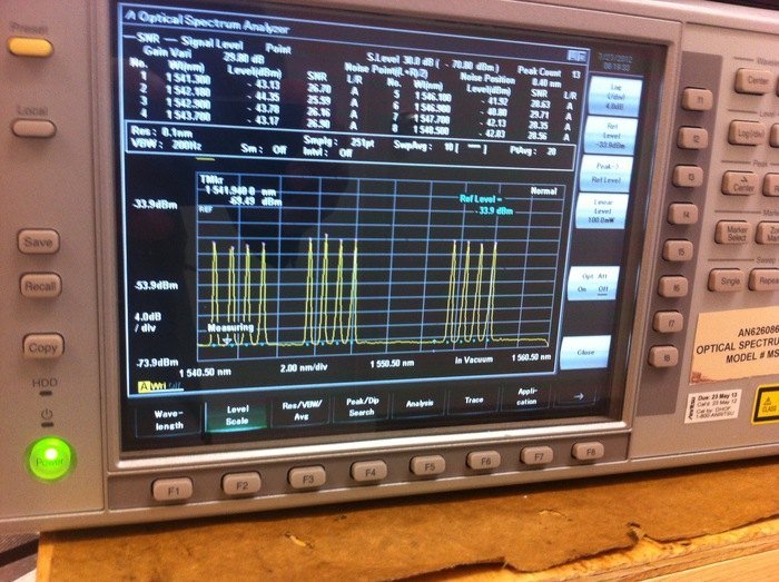 OOI RSN and L-3 MariPro personnel at the shore station in Pacific City, Oregon, were actively involved in primary node installation operations. They monitored activities as the system was powered on and off during ship-based tests and deployments. Shown here is the screen of an Optical Spectrum Analyzer (OSA) at the shore station. The twelve peaks shown are actually the twelve wavelengths coming from the three RSN Primary Nodes connected at the time--PN1A, PN1B, and PN1C. Each Node has two traffic wavelengths of 10gb/s each and two wavelengths for system management. Photo by Pete Barletto 