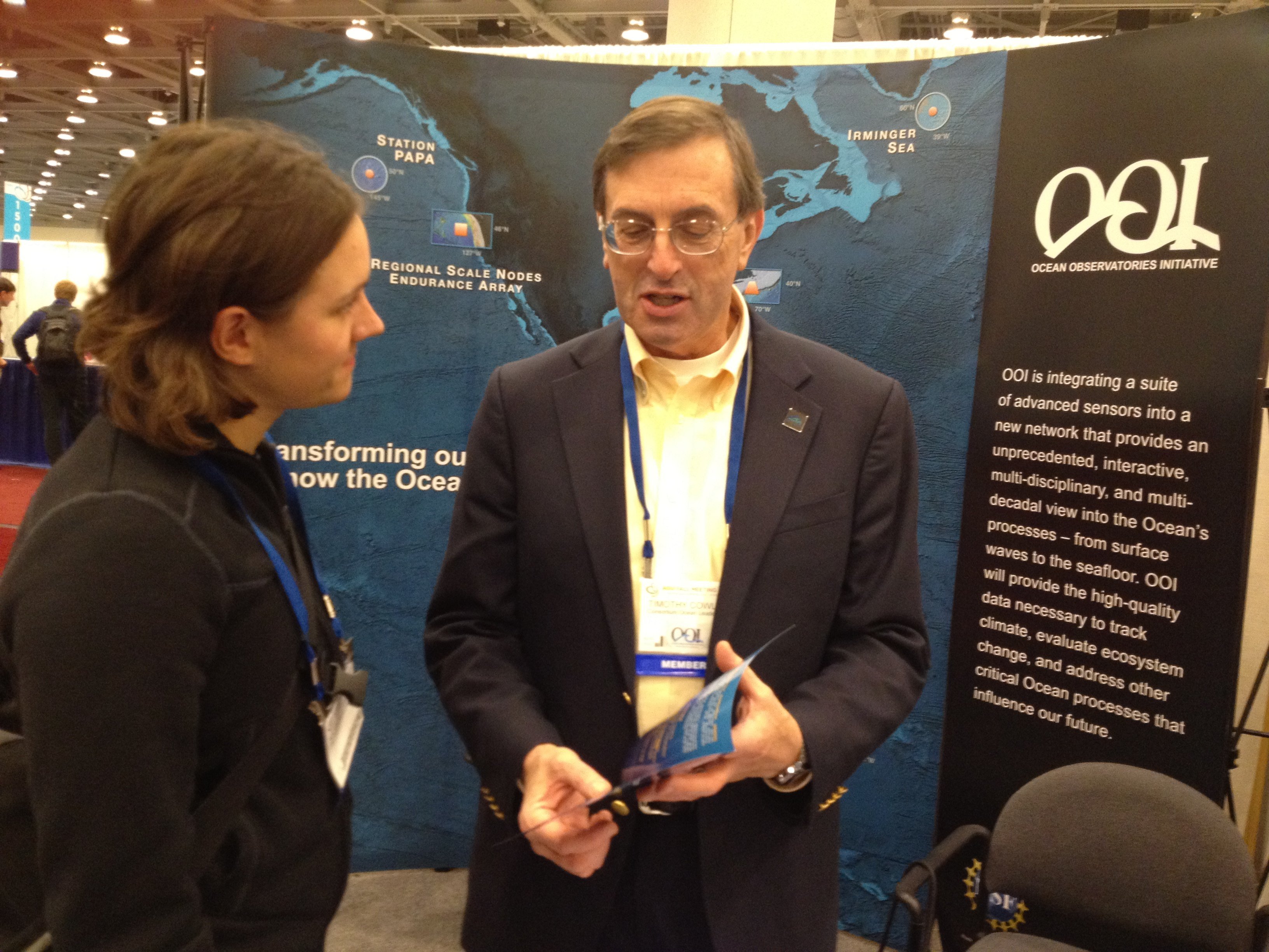 Tim Cowles, Vice President and Director of Ocean Observing, discusses the Ocean Observatories Initiative with Dr. Natalie Griffiths, Postdoctoral Research Associate, Oak Ridge National Laboratory, at the OOI booth during the American Geophysical Union fall meeting in San Francisco, Calif., in December. (Credit: OOI Program Management Office Communications)