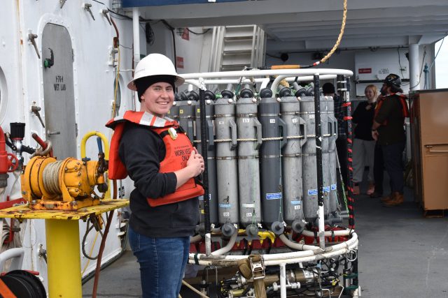 Morrigan stands on deck of R/V Atlantis