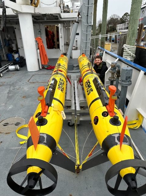 Two OOI REMUS AUVs staged aboard the RV Virginia for their February 2025 mission as OOI technician Andy Robinson does final checks before leaving the dock.