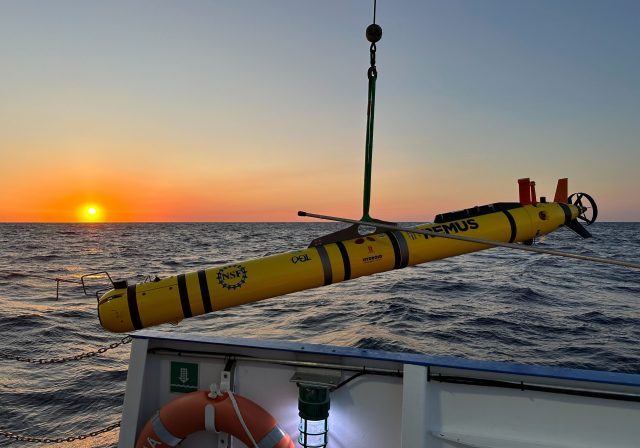 AUV deployment off ship with sunset