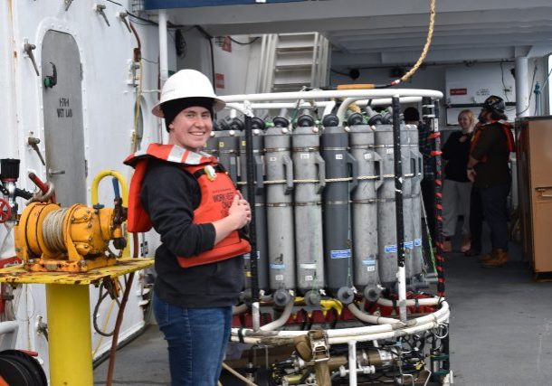 Morrigan stands on deck of R/V Atlantis