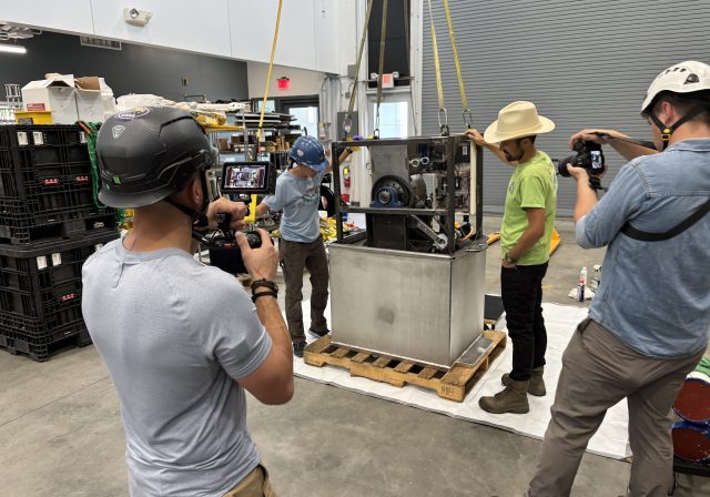 IMG_2131 (1) Joshua Bauer, NREL; Taylor Mankle, NREL; Meghan Donohue, WHOI; and Alex Franks, WHOI, install the WEC system into its watertight housing. © Ken Kostel, WHOI