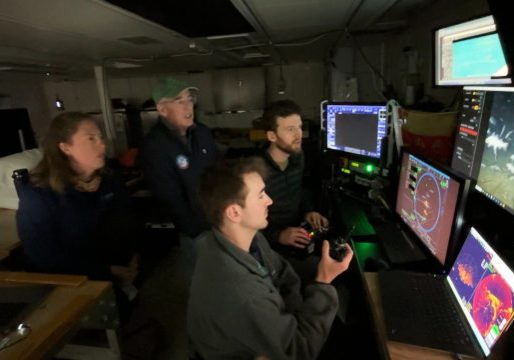 Sam Dahlberg (foreground) provides navigational support and situational awareness while Andy Robinson pilots the ROV and WHOI biologist Kirstin Meyer-Kaiser and co-chief scientist David Mearns watch the survey of Quest. Credit: Ken Kostel, © Woods Hole Oceanographic Institution